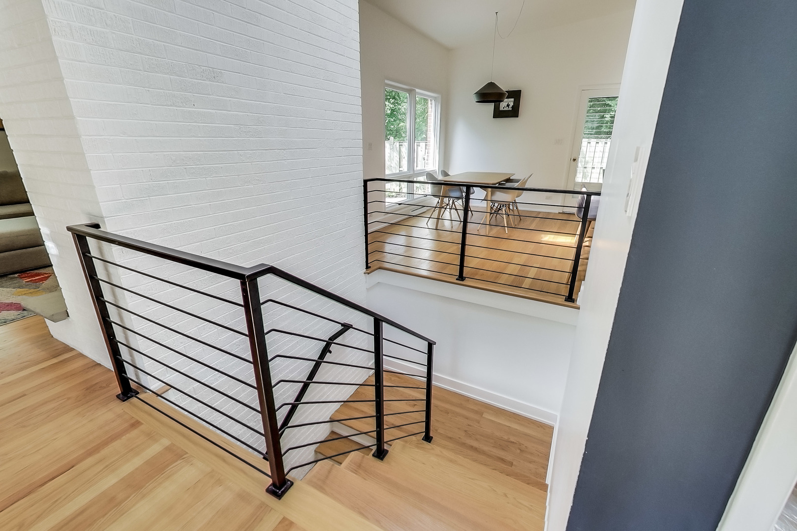 416 Maple Street Winnetka, IL 60093 - Photo 10 of 34 a view of staircase with wooden floor and a window