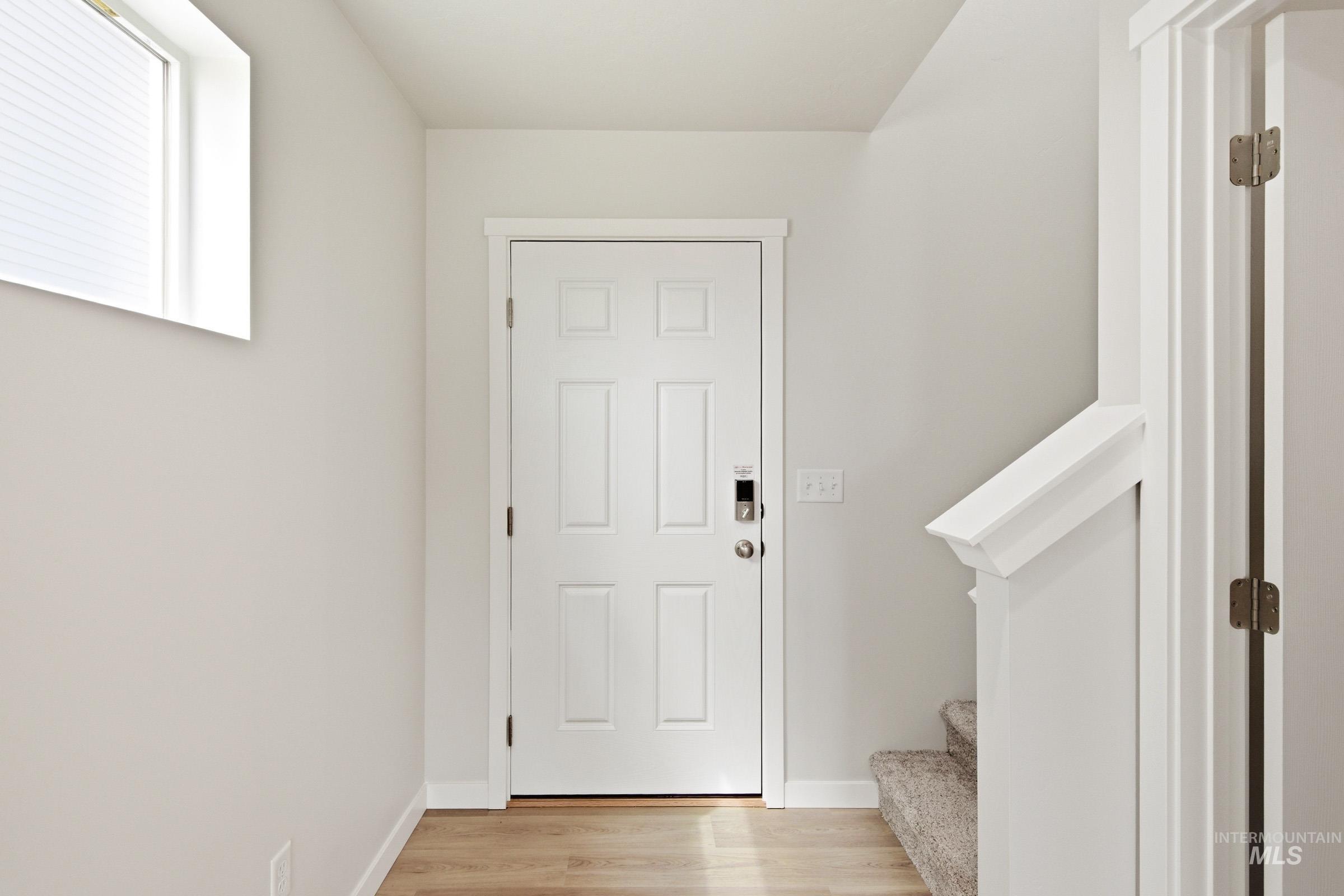 2446 West Fallon Loop Nampa, ID 83651 - Photo 2 of 19 Entryway with stairway and light wood-style floors