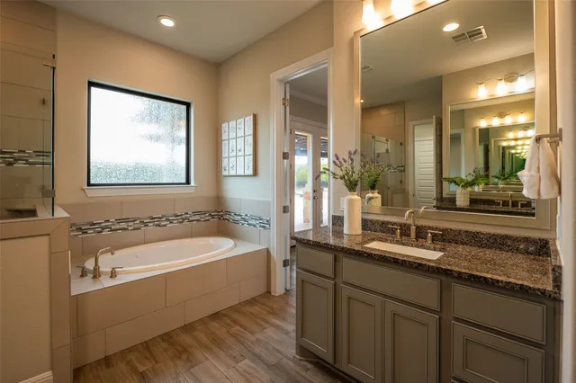 a view of a patio with a dining table and chairs with a barbeque grill and a small yard