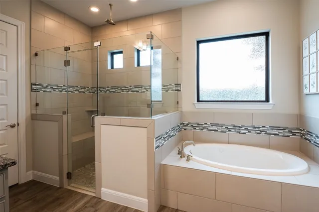 a view of swimming pool with seating space and trees in the background