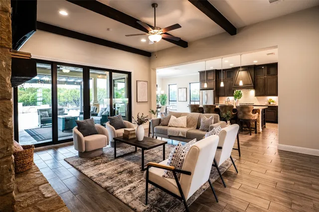 an aerial view of a house with swimming pool and mountains
