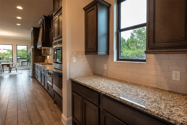 an aerial view of multiple houses with a yard