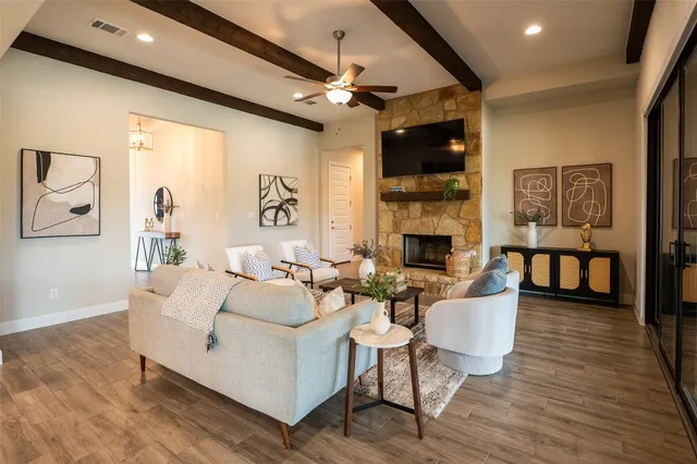 a dining room with wooden floor and large windows