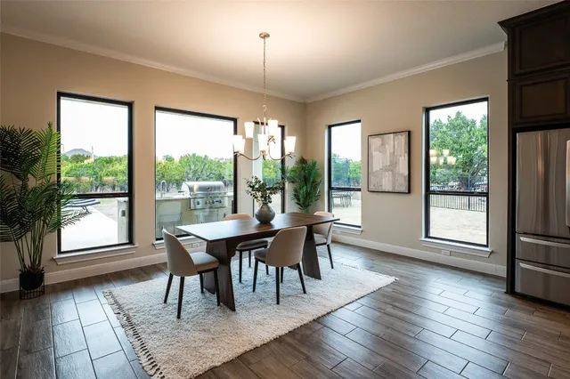 a dining room with furniture and a potted plant