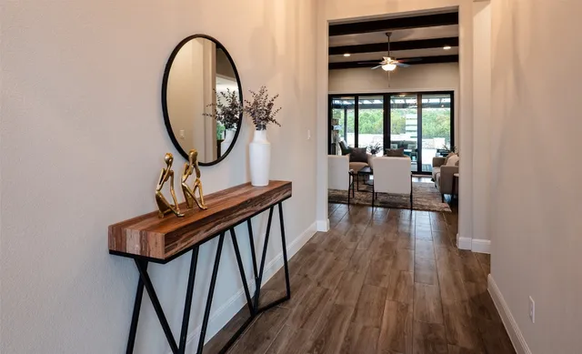 a bathroom with a granite countertop sink a mirror and a shower