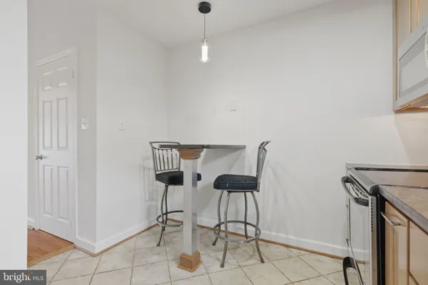 a view of a room with a table and chairs