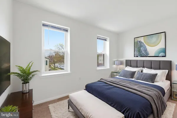 a bedroom with a bed and a potted plant