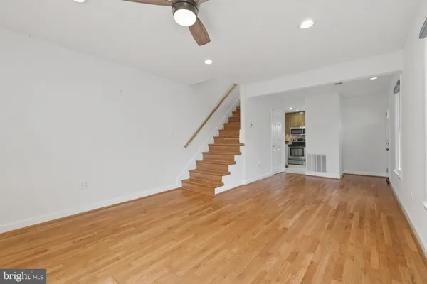 a view of empty room with wooden floor
