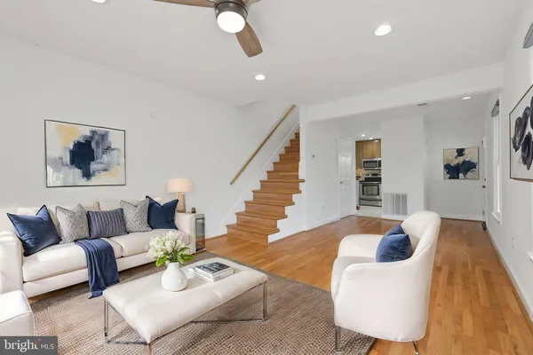 a living room with furniture and a wooden floor