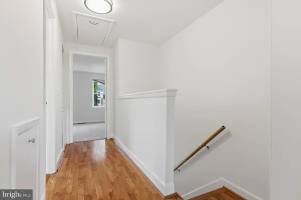 a view of hallway with wooden floor