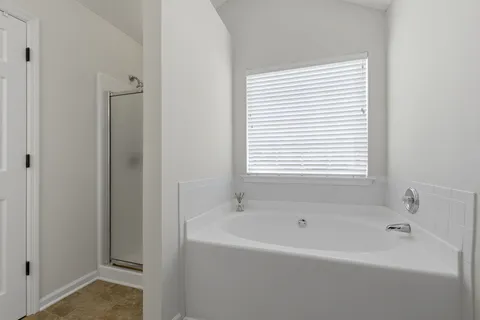 a white bath tub sitting next to a window