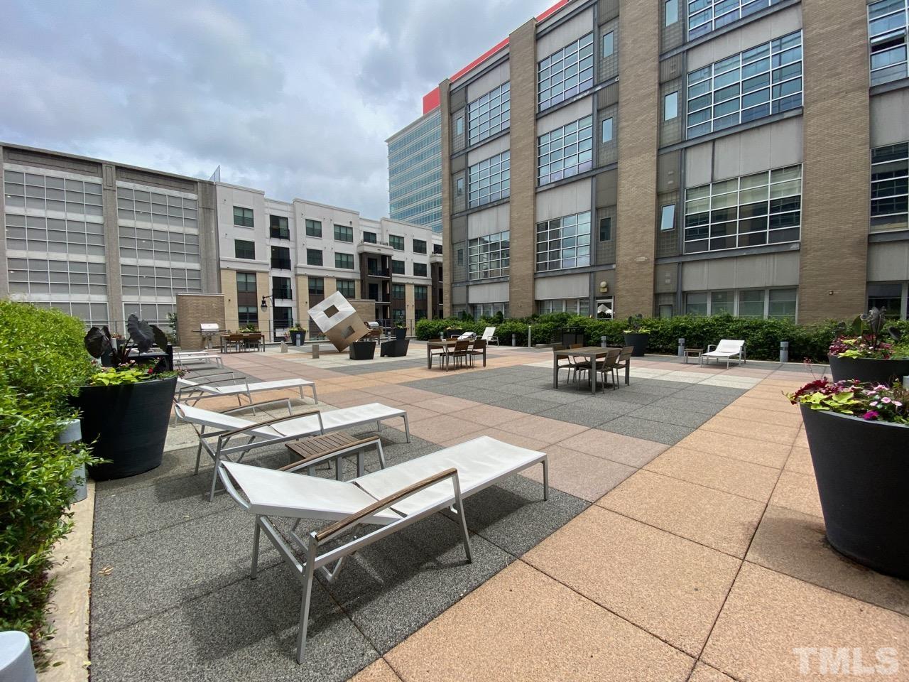 319 Fayetteville Street, Unit 407 Raleigh, NC 27601 - Photo 3 of 3 a building outdoor space with patio furniture and potted plants