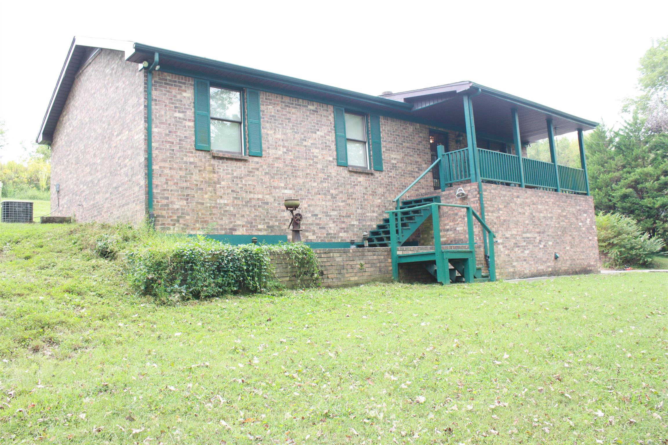 a view of a house with a yard and sitting area