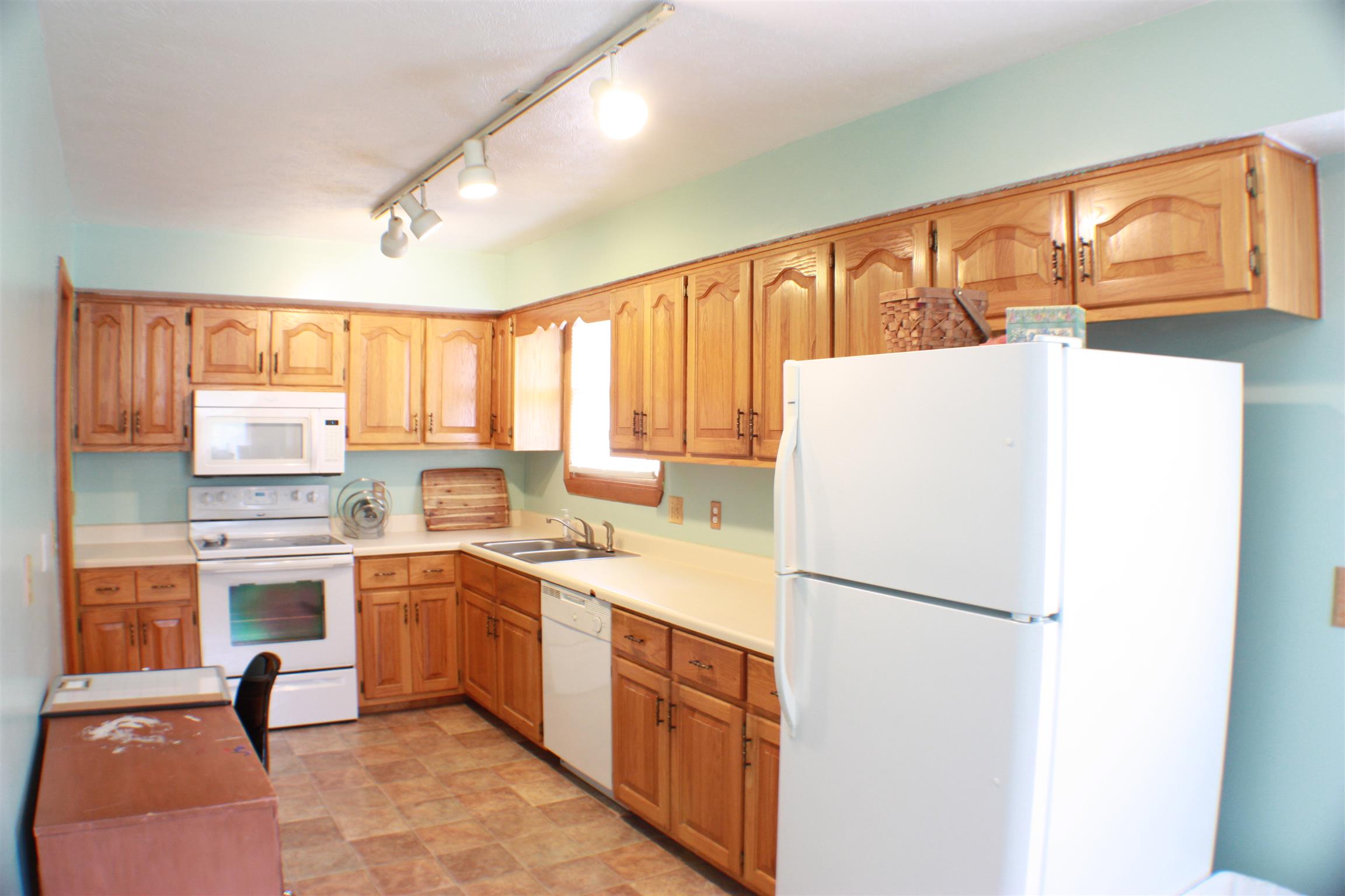 201 Vantrease Road Cottontown, TN 37048 - Photo 7 of 13 a kitchen with a refrigerator a sink and cabinets
