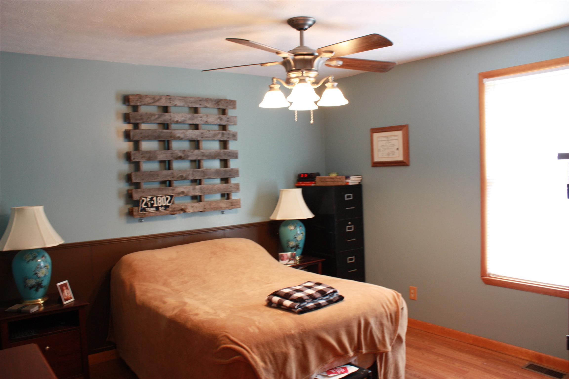 201 Vantrease Road Cottontown, TN 37048 - Photo 9 of 13 a bedroom with a bed and a chandelier