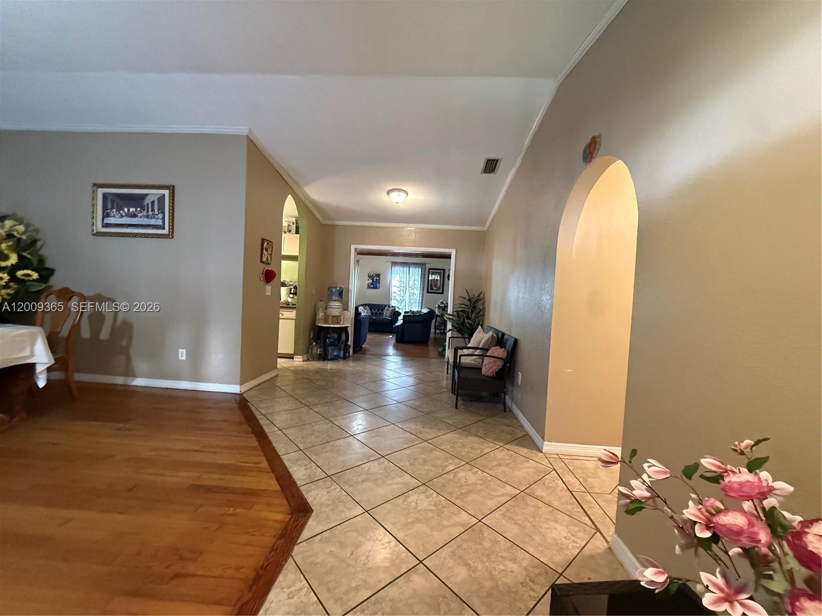 25835 Southwest 131st Court Homestead, FL 33032 - Photo 12 of 33 a spacious bedroom with a bed and a chandelier