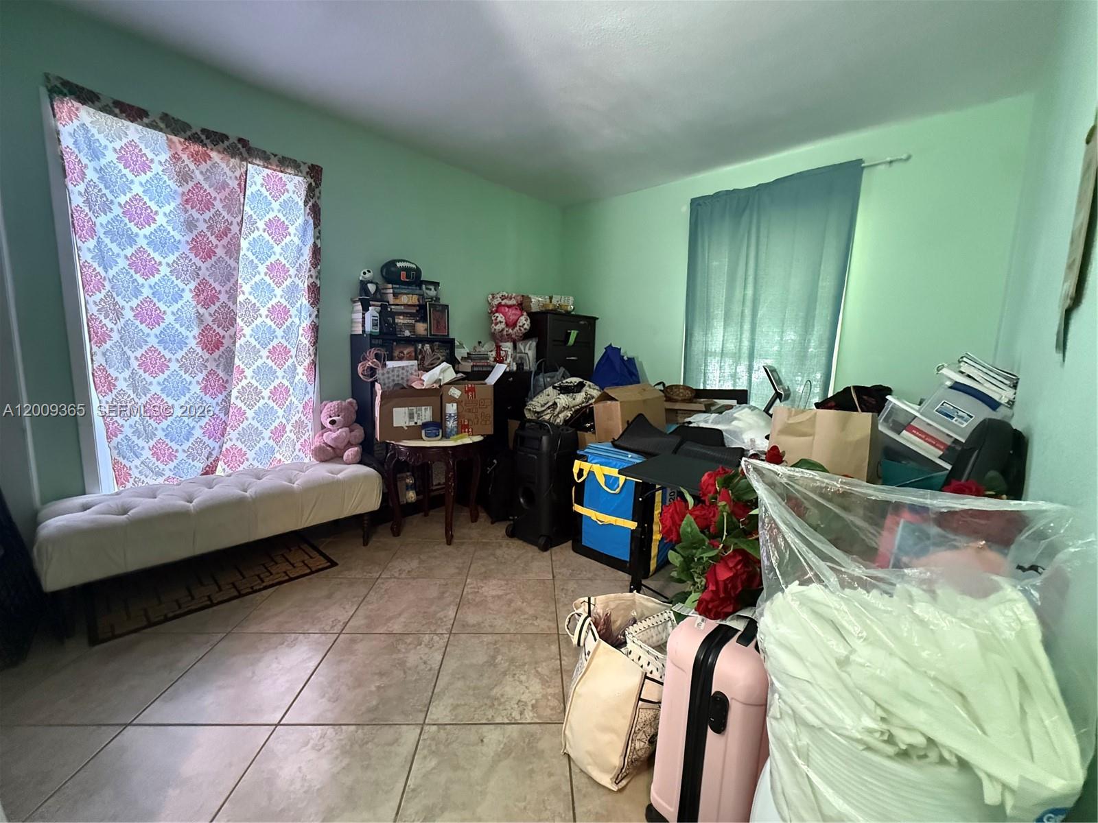 25835 Southwest 131st Court Homestead, FL 33032 - Photo 15 of 33 a bed room with a bed and a couch