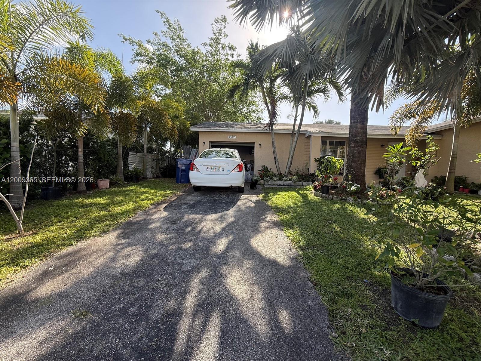 25835 Southwest 131st Court Homestead, FL 33032 - Photo 2 of 33 a view of a backyard with a car parked in it