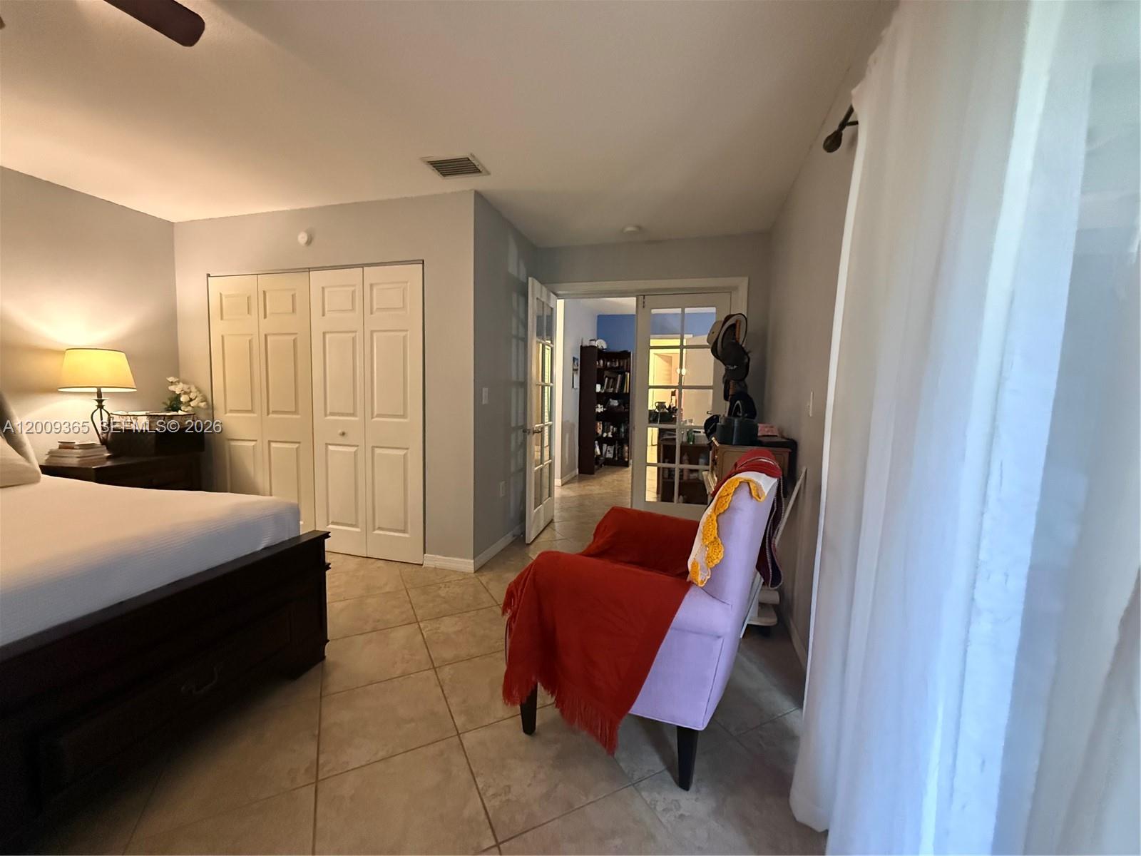 25835 Southwest 131st Court Homestead, FL 33032 - Photo 22 of 33 a bedroom with furniture and a lamp