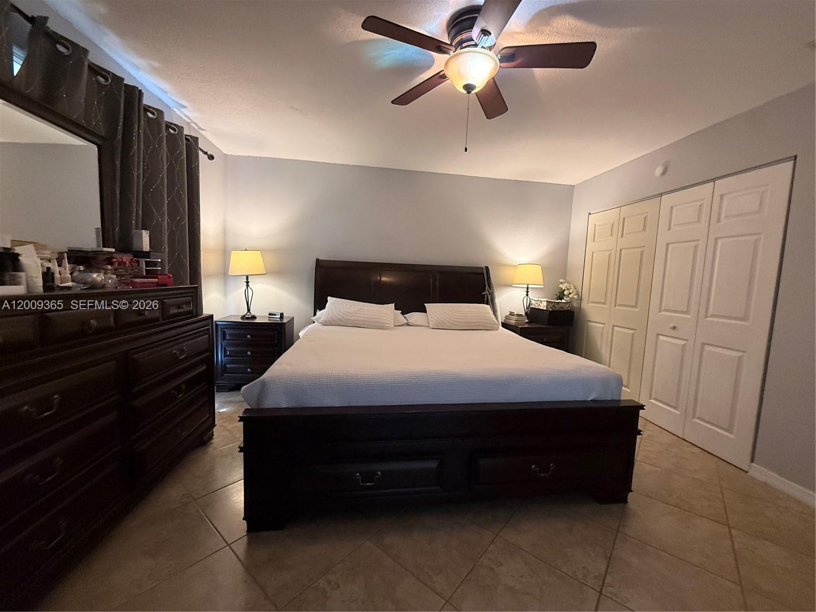 25835 Southwest 131st Court Homestead, FL 33032 - Photo 23 of 33 a bedroom with a bed and a chandelier