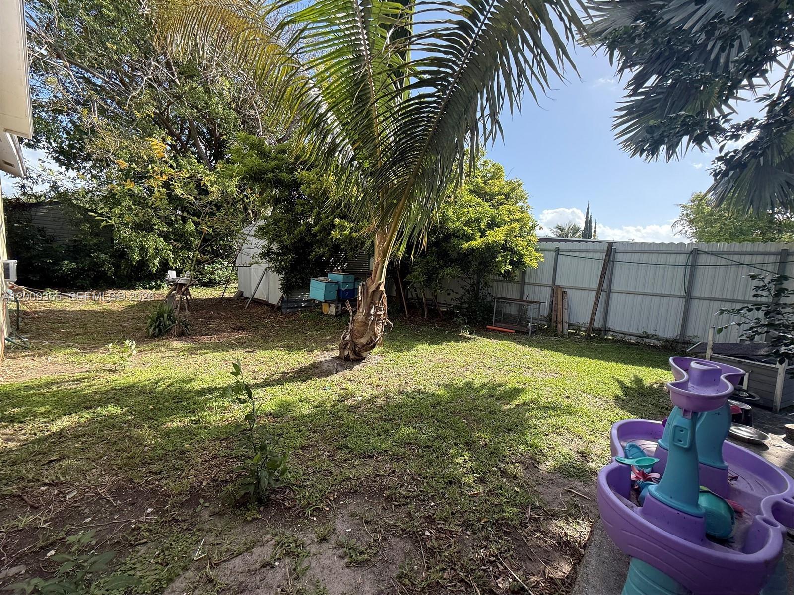 25835 Southwest 131st Court Homestead, FL 33032 - Photo 24 of 33 a backyard of a house with table and chairs