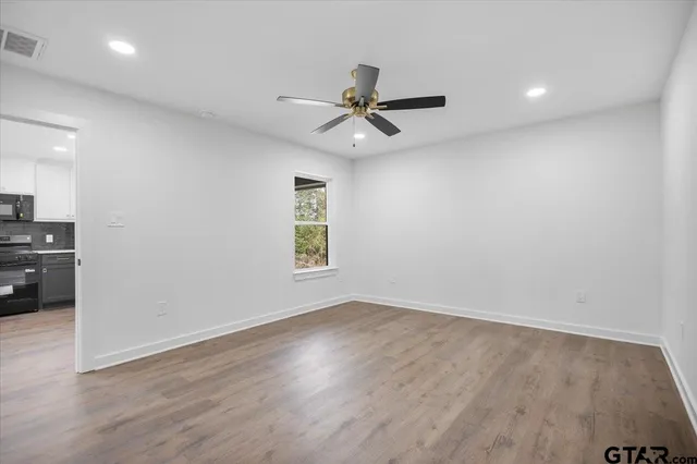 wooden floor in an empty room with a window