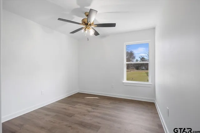 a view of an empty room and wooden floor