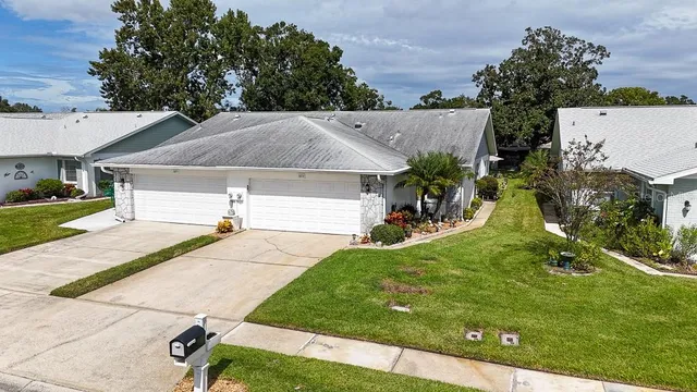 a view of a house with backyard and sitting area