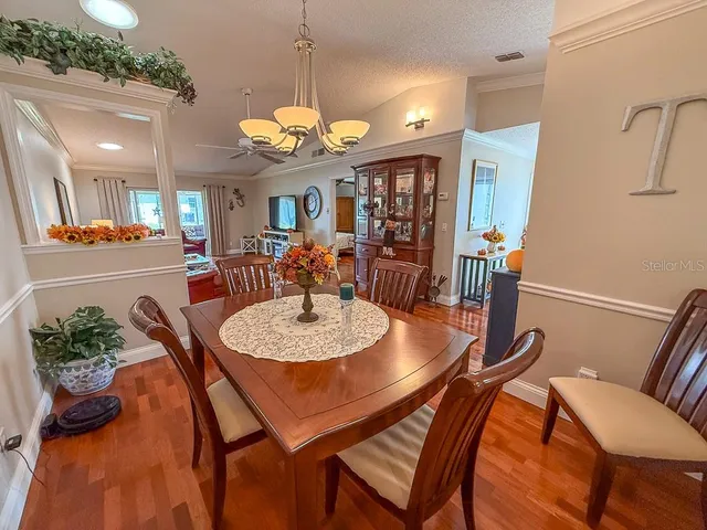 a living room with furniture a ceiling fan and a rug