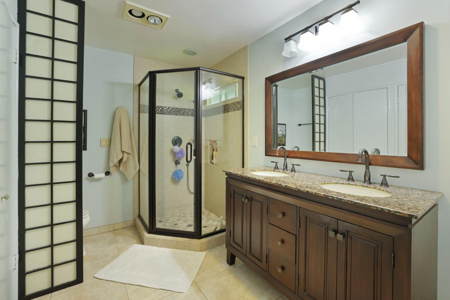 2406 Kenmore Court Modesto, CA 95350 - Photo 34 of 54 a bathroom with a double vanity sink and mirror