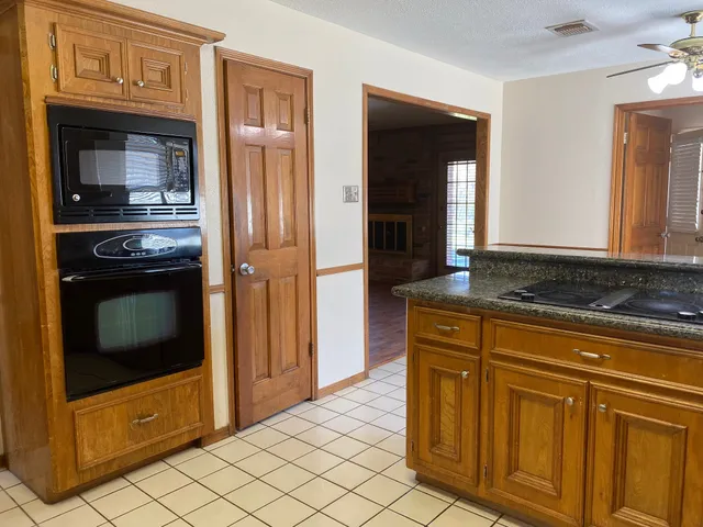 a kitchen with stainless steel appliances granite countertop a refrigerator and a stove top oven