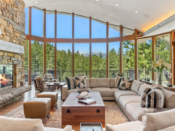 a living room with large windows and a table