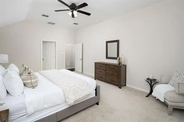 a bedroom with a bed and a dresser