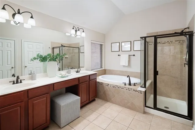 a spacious bathroom with a bathtub shower sink mirror and