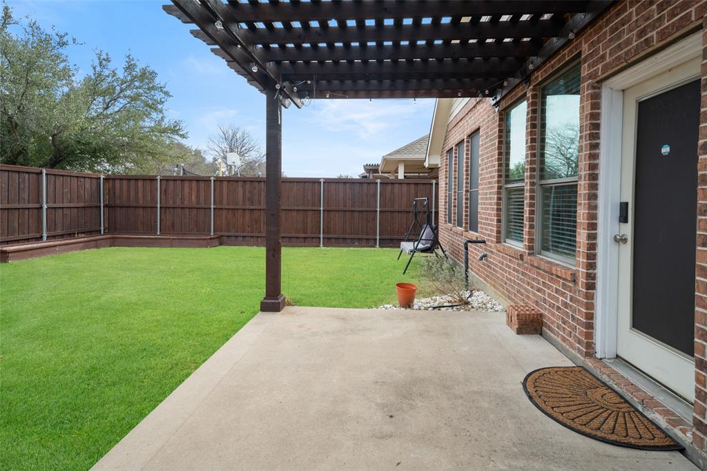 7518 Forest Ridge Trail Sachse, TX 75048 - Photo 27 of 40 a view of a backyard with a slide