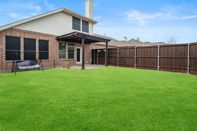 a view of a house with a yard and sitting area