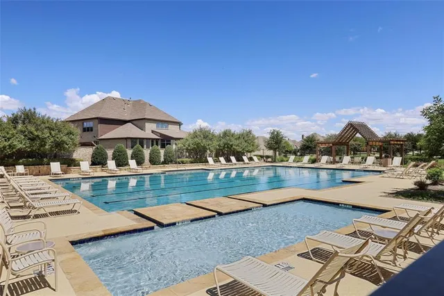 a view of swimming pool with outdoor seating and lake view