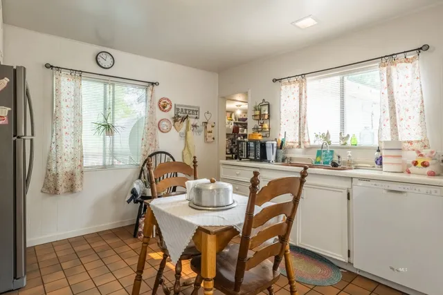 a dining room with furniture and window