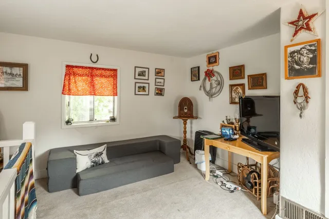 a bedroom with furniture and a window