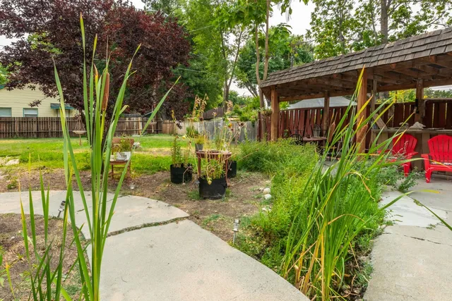 a view of house with backyard and garden