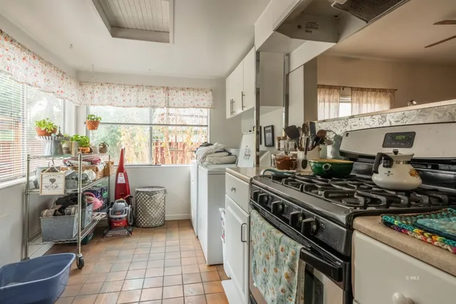 a kitchen with a stove and a white cabinet