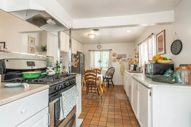 a kitchen with stainless steel appliances granite countertop a stove and a sink