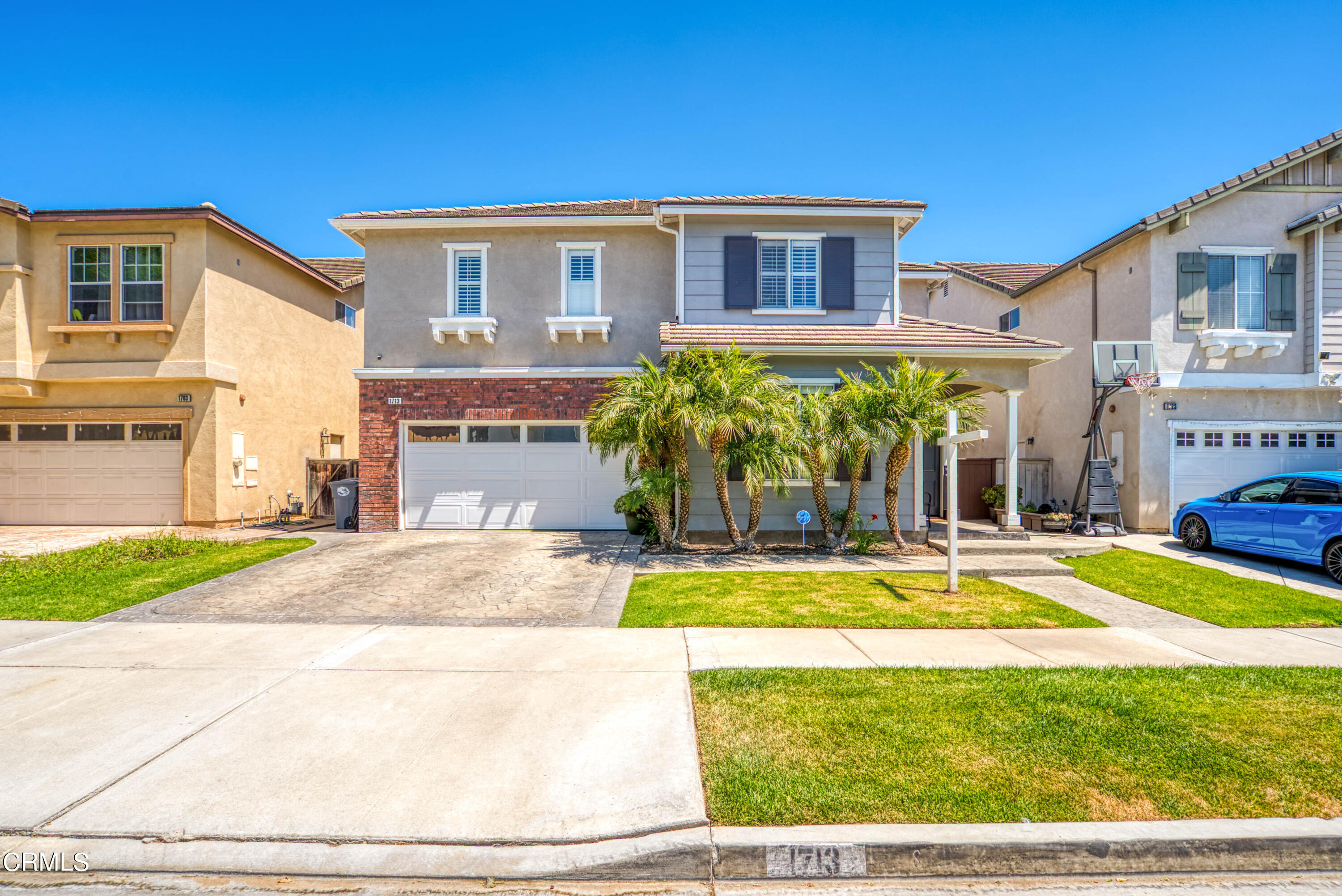 a view of a house with a swimming pool and a yard