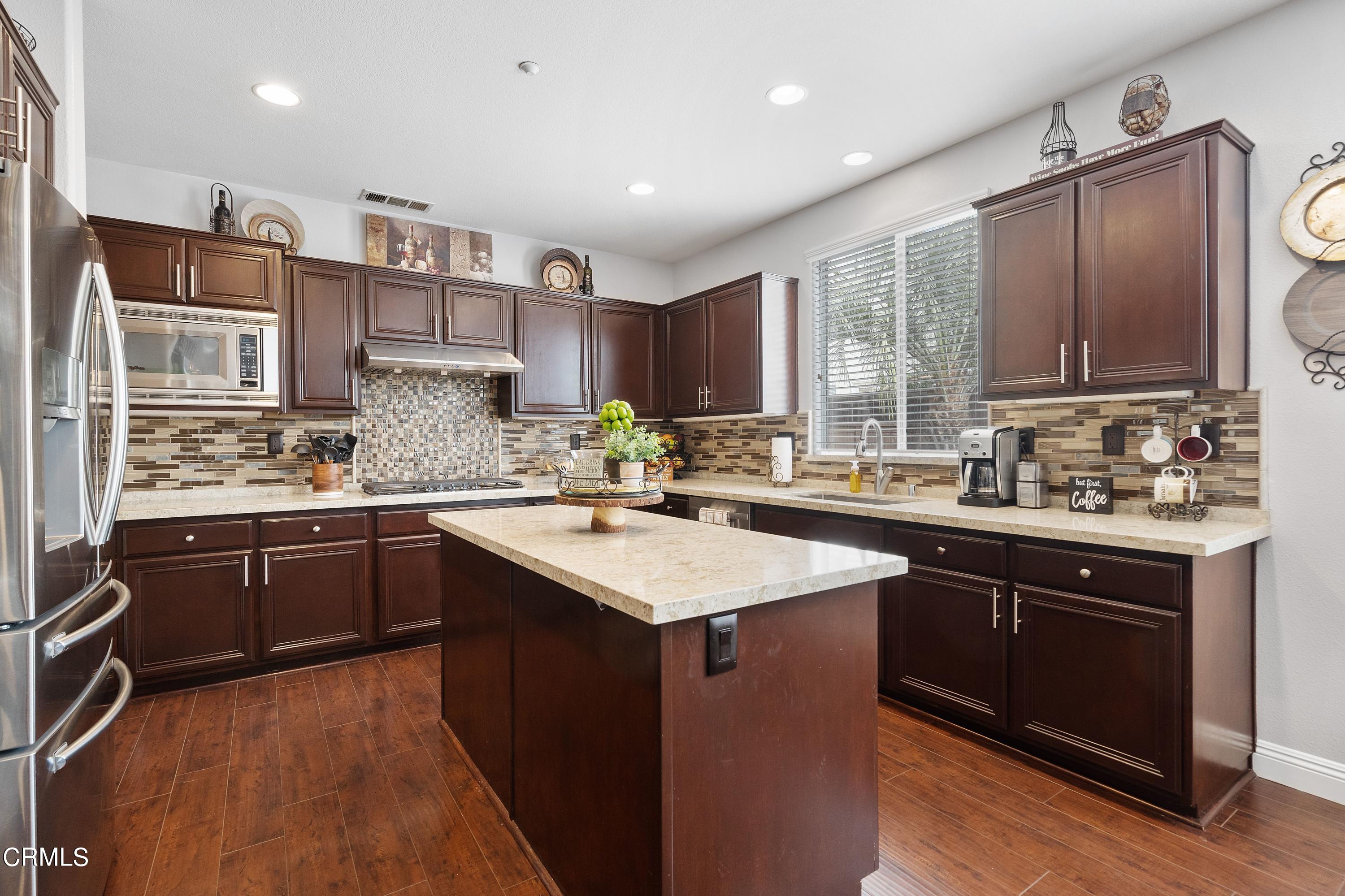1713 Tiesa Lane Oxnard, CA 93030 - Photo 3 of 48 a kitchen with a sink stove and cabinets