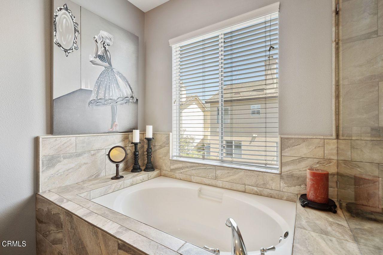 1713 Tiesa Lane Oxnard, CA 93030 - Photo 21 of 48 a bathroom with a tub sink and a window