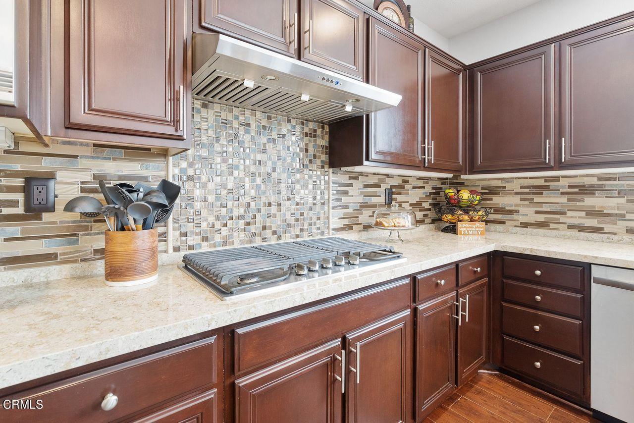 1713 Tiesa Lane Oxnard, CA 93030 - Photo 4 of 48 a kitchen with stainless steel appliances granite countertop a sink dishwasher and cabinets with wooden floor
