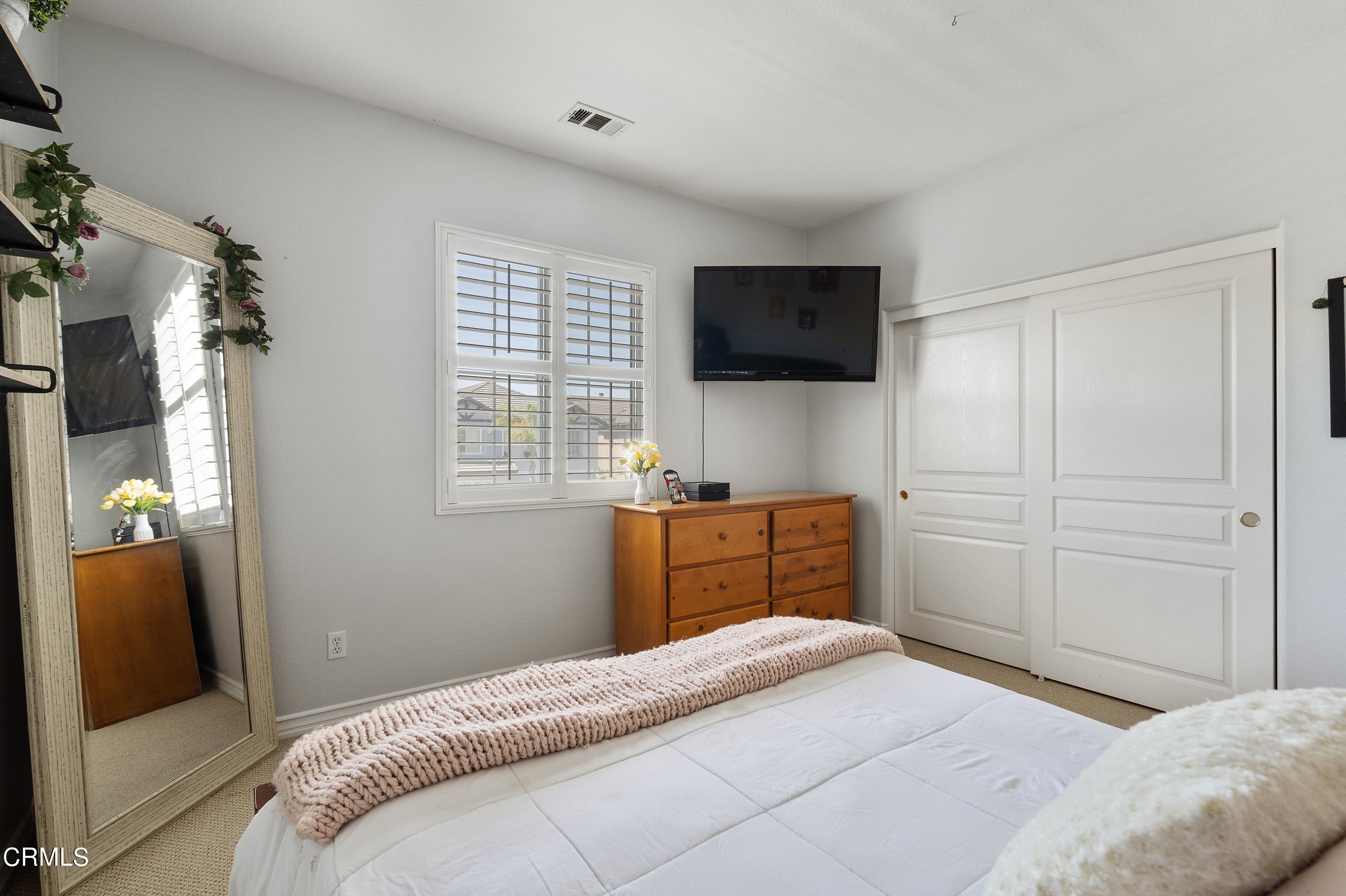 1713 Tiesa Lane Oxnard, CA 93030 - Photo 32 of 48 a bedroom with a bed and flat screen tv