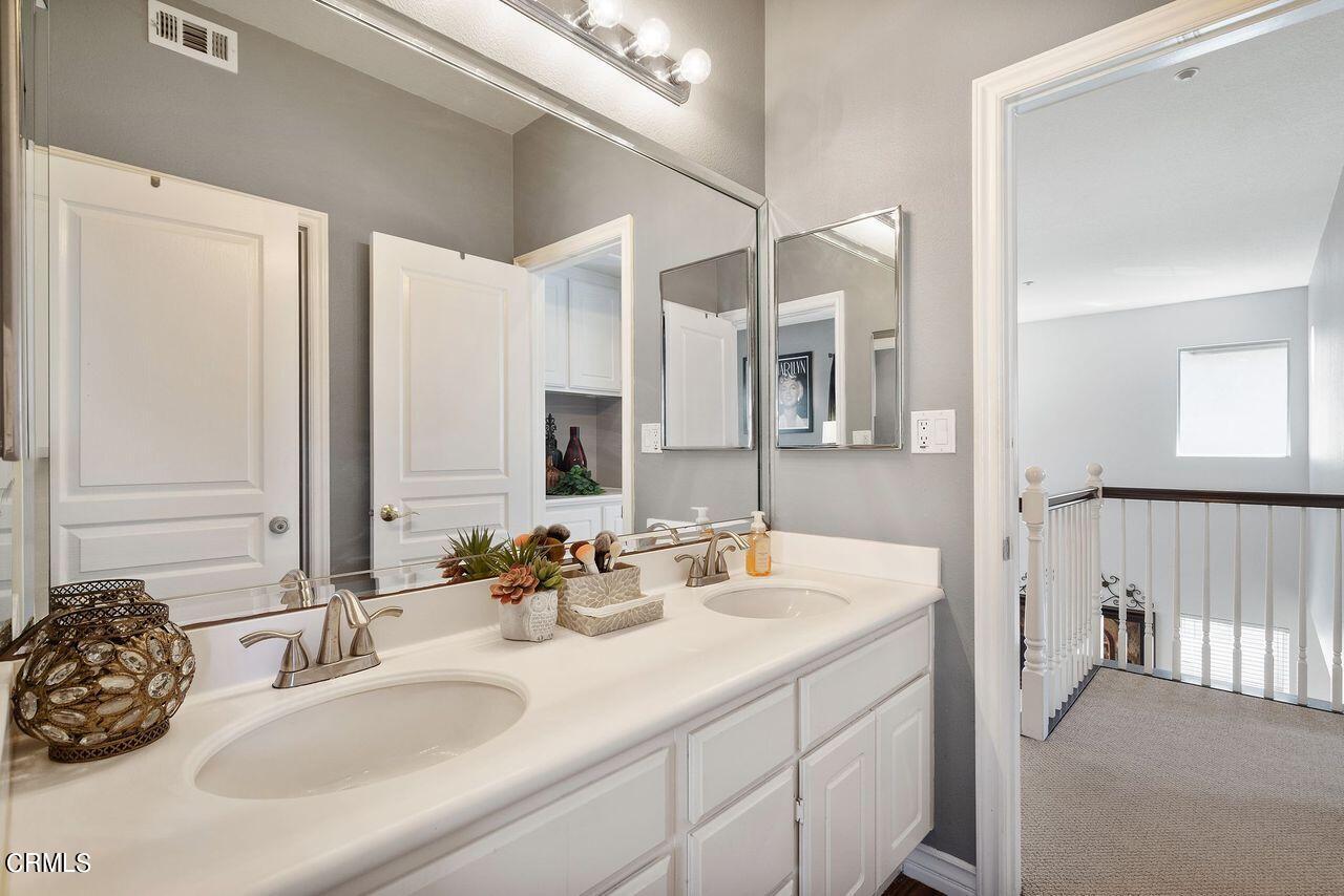 1713 Tiesa Lane Oxnard, CA 93030 - Photo 34 of 48 a bathroom with a double vanity sink and a mirror