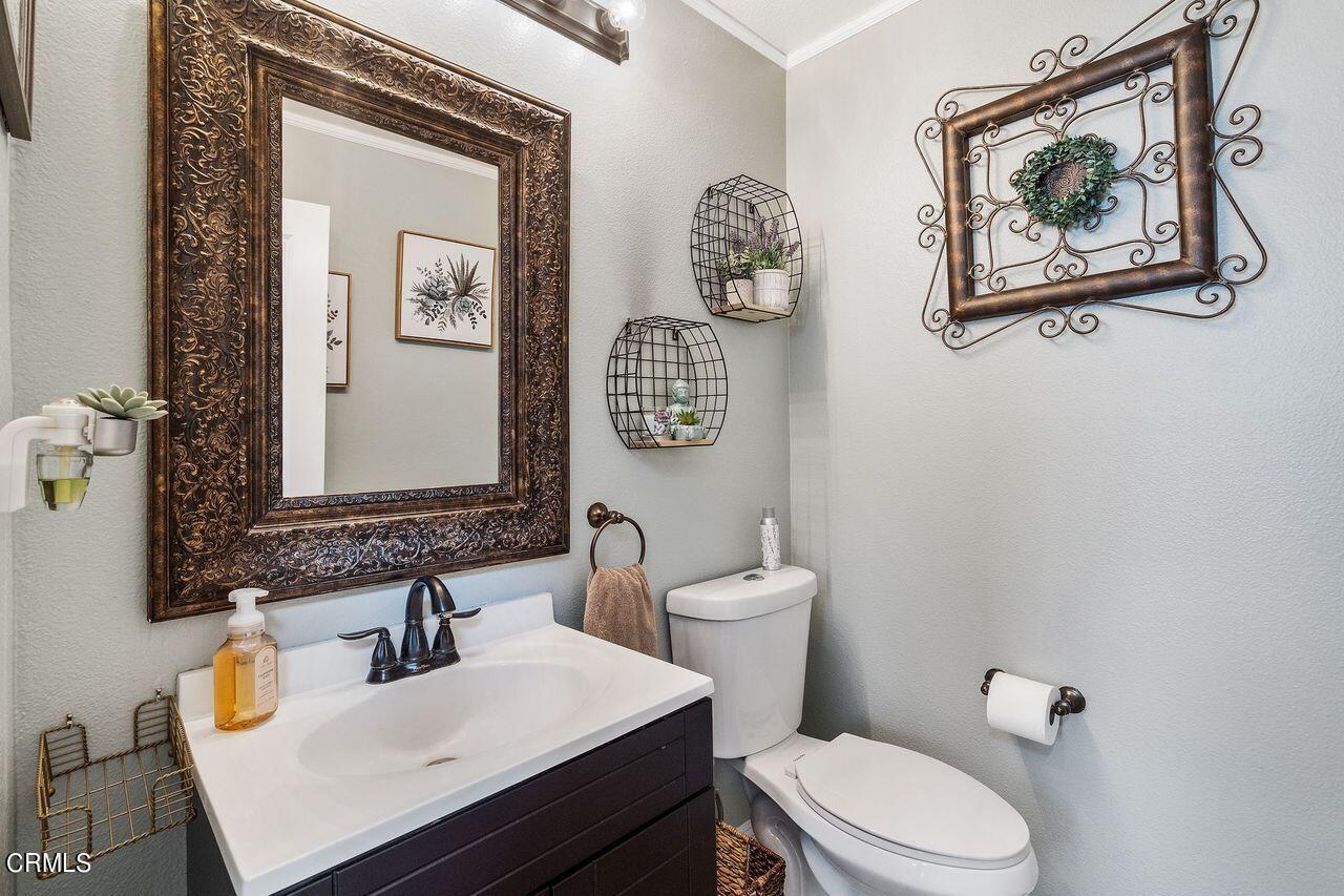 1713 Tiesa Lane Oxnard, CA 93030 - Photo 40 of 48 a bathroom with a toilet a sink and mirror