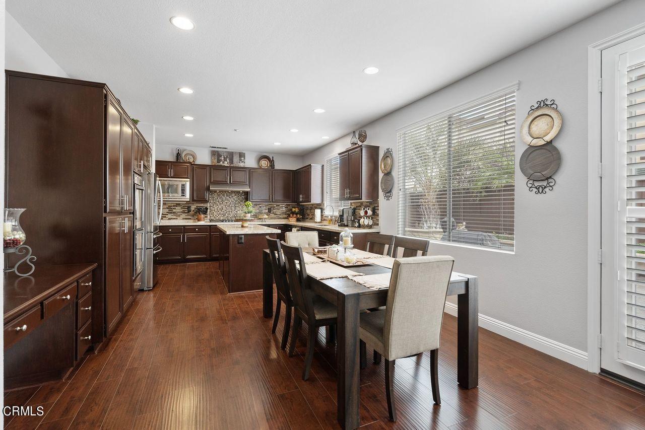1713 Tiesa Lane Oxnard, CA 93030 - Photo 6 of 48 a kitchen with a table chairs refrigerator and microwave